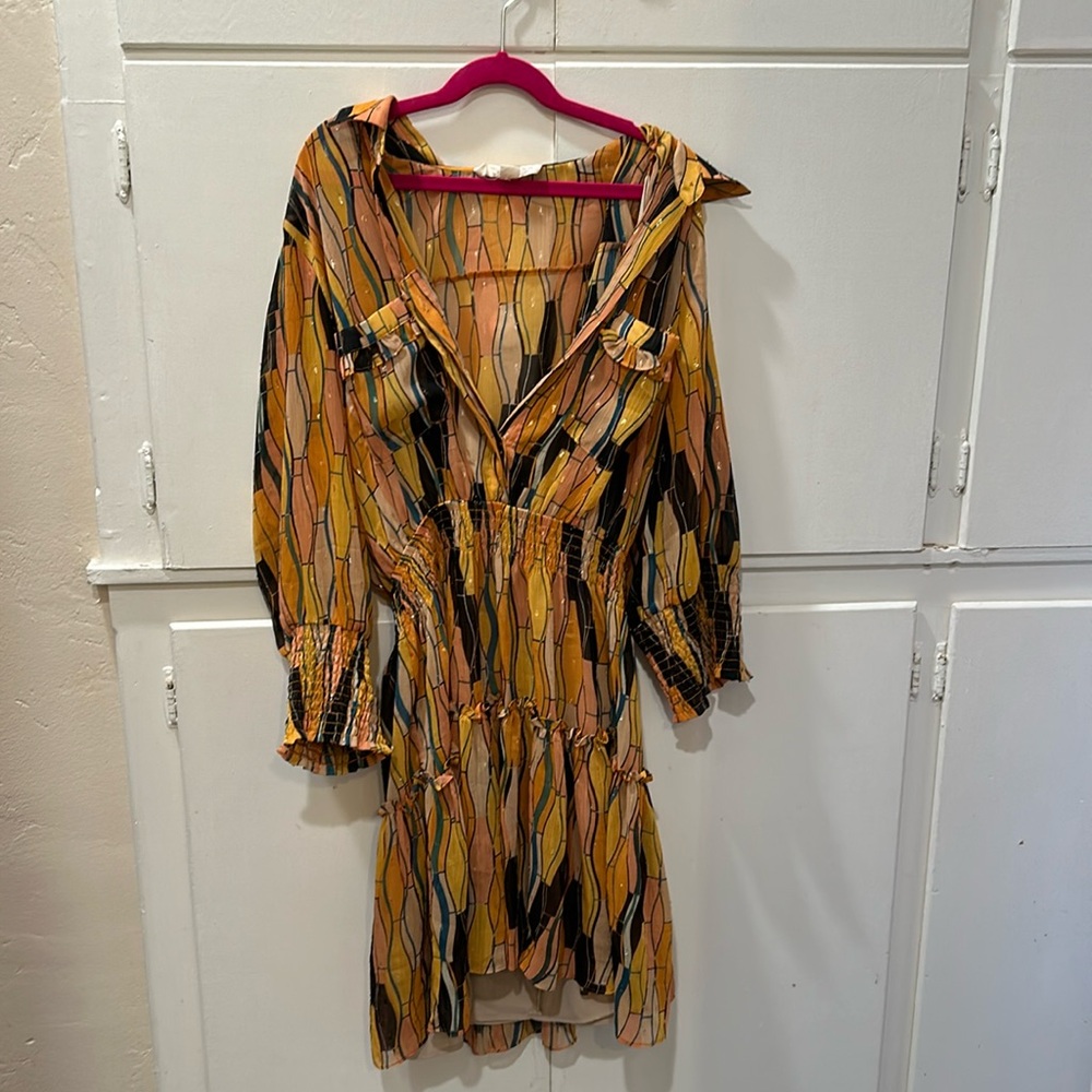 Beautifully designed dress with gold detailing and a cinched waistband.